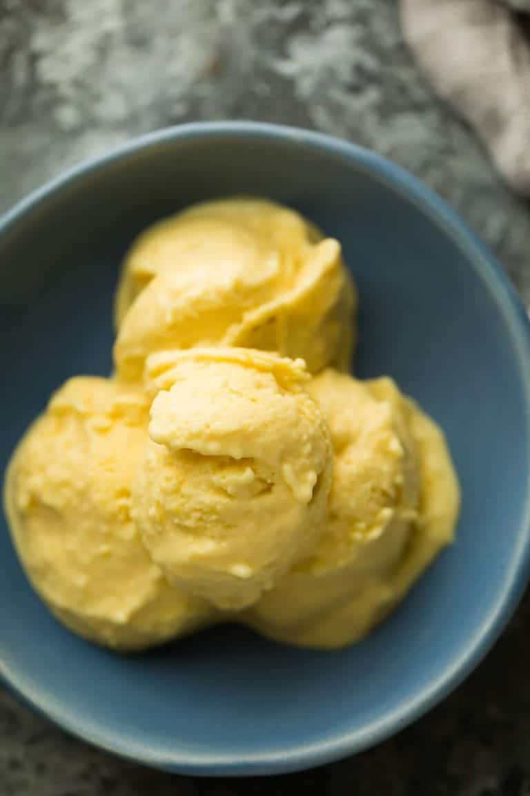 blue bowl with scoops of mango greek frozen yogurt