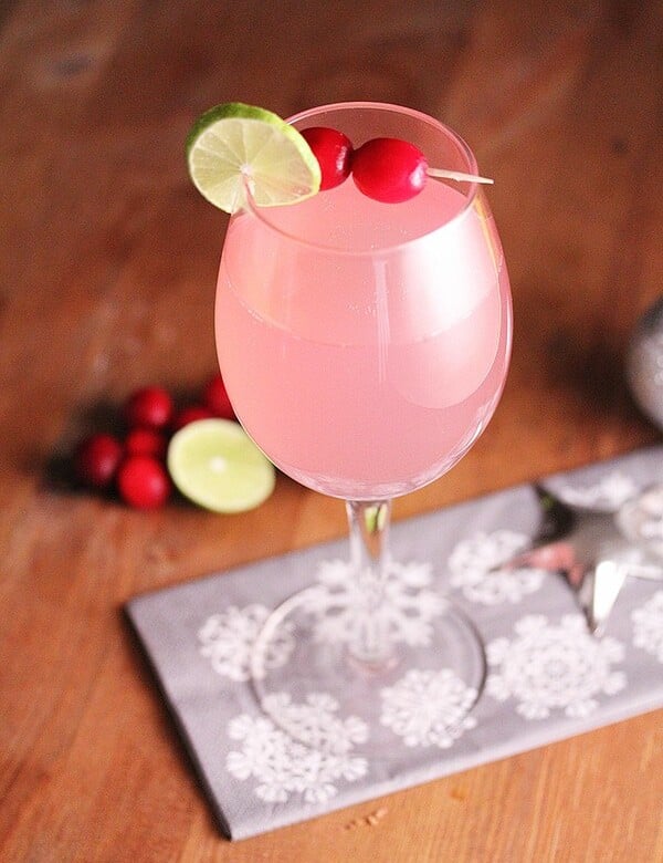 cranberry ginger fizz in wine glass on wood table
