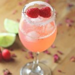 raspberry rosewater gin rickey in glass with lime in background