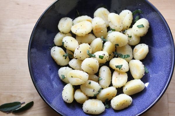 Overhead view of Gnocchi with Sage and Black Pepper in a blue bowl