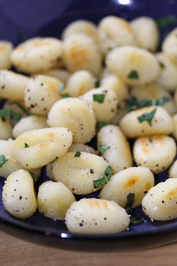 Gnocchi with Sage and Black Pepper on a blue plate