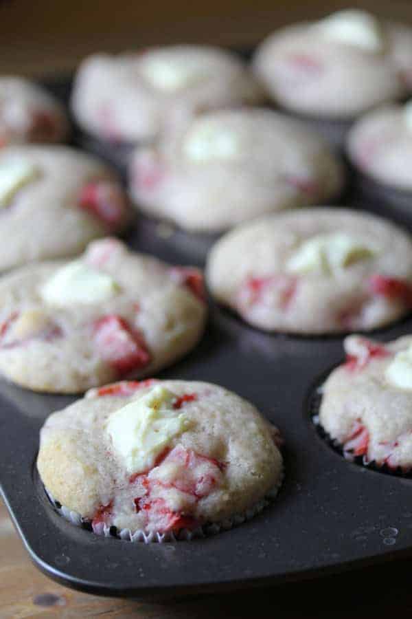Strawberries and Cream Cheese Muffins in a muffin tin after baking