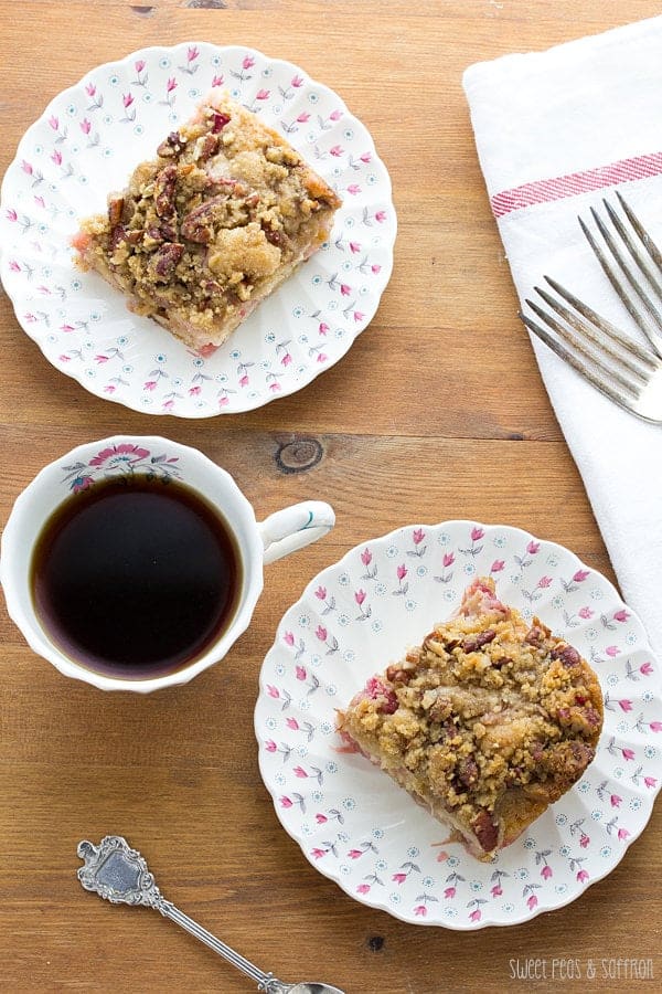 Overhead view of Rhubarb Buttermilk Coffee Cake on plates with forks and a cup of coffee