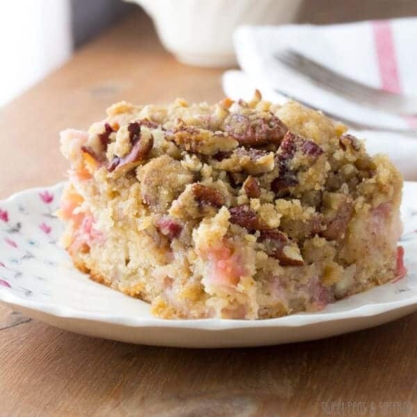 slice of rhubarb coffee cake with nutmeg and pecan streusel on plate