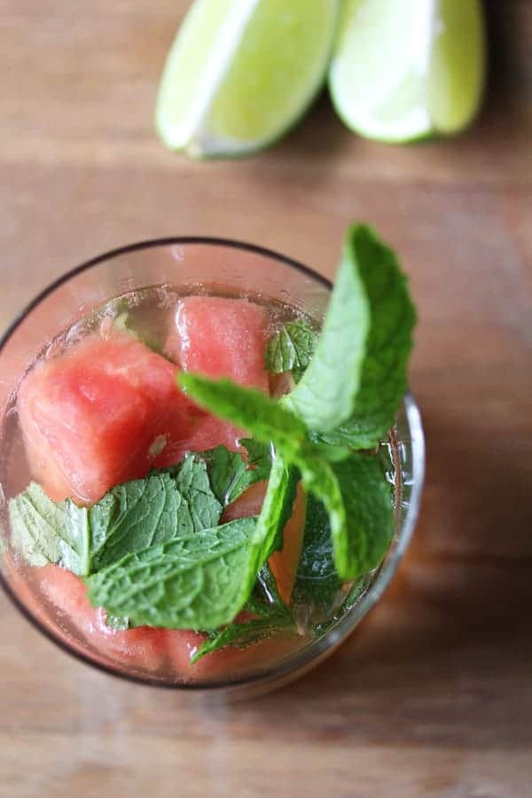 Overhead shot of Watermelon Sangria in a glass with fresh mint and lime garnish