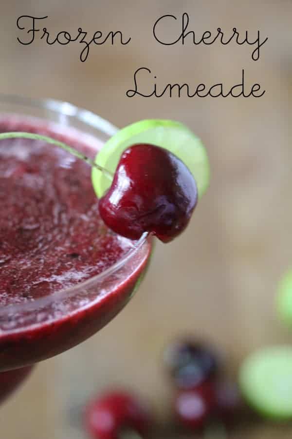 Frozen Cherry Limeade in a margarita glass with fresh cherry garnish