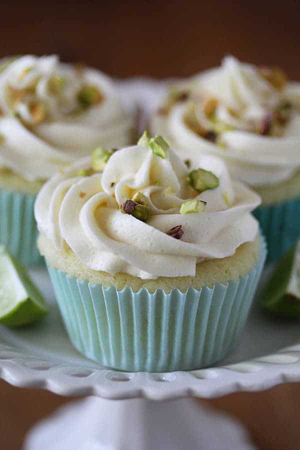 Close up shot of Key Lime Cupcakes with White Chocolate Frosting and Pistachios 