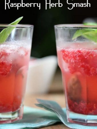 two raspberry smash cocktails on blue napkin