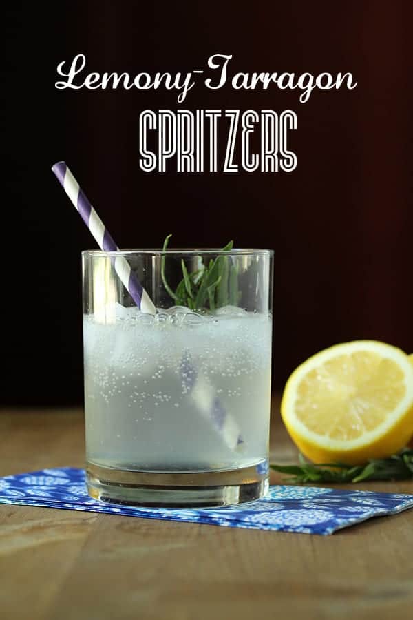 Lemon Tarragon Spritzer in a glass with striped straw and half a lemon