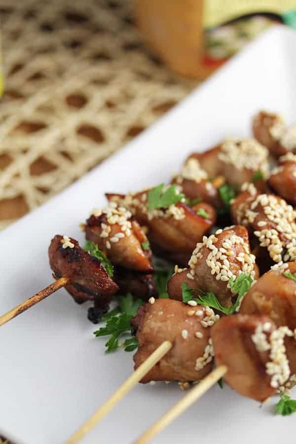 Close up shot of Miso and Sesame Grilled Chicken Kebabs on white serving plate