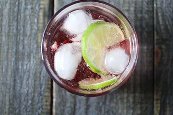 Overhead view of Pomegranate and Rosewater Spritzer with a lime slice