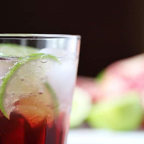 side view of pomegranate rosewater spritzer in glass