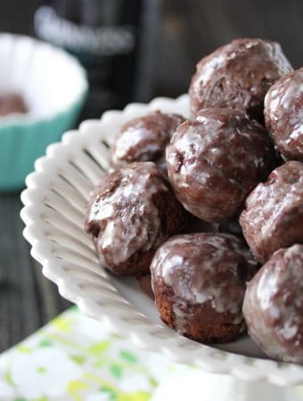 pile of guinness chocolate glazed donut holes in white bowl