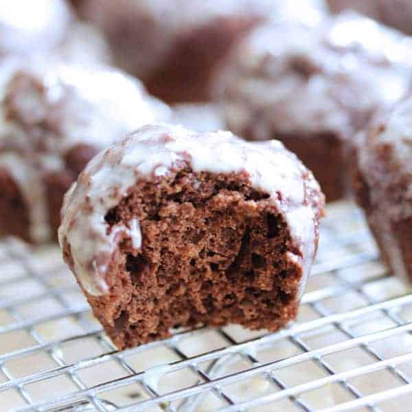 Close up shot of Chocolate Glazed Donut Hole with a bite taken out of it