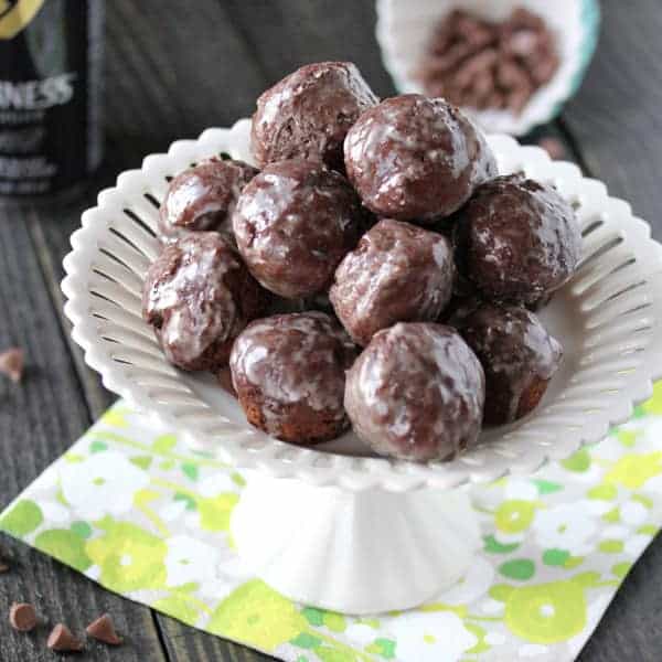 Pile of Chocolate Glazed Donut Holes in a white dish