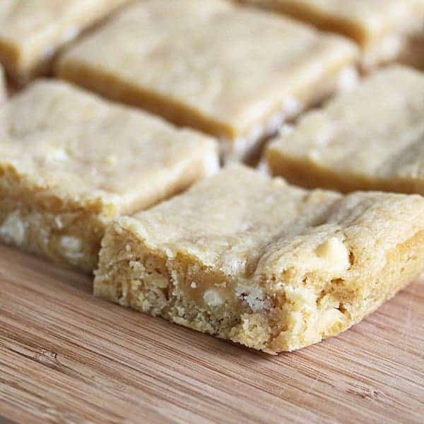 Close up shot of Key Lime Blondies on a wood board before white chocolate drizzle