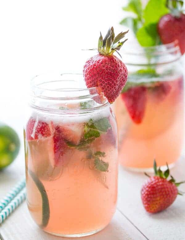 two glass mason jars with strawberry rhubarb rose sangria