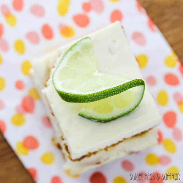Overhead shot of Lime Cheesecake Bars on a colorful napkin