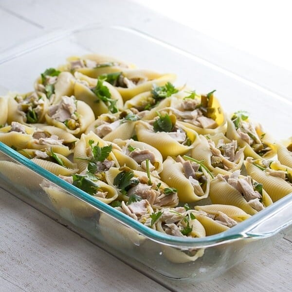 cheesy jalapeno and chicken stuffed pasta shells in glass container