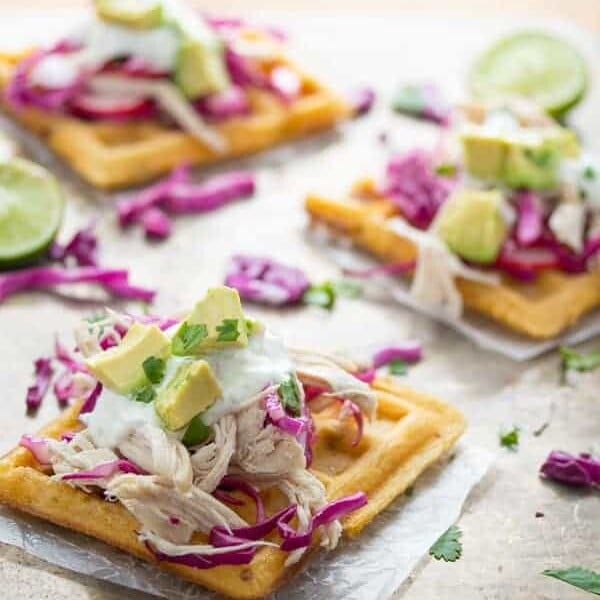 three chipotle cornmeal waffle tostadas with lime and avocado
