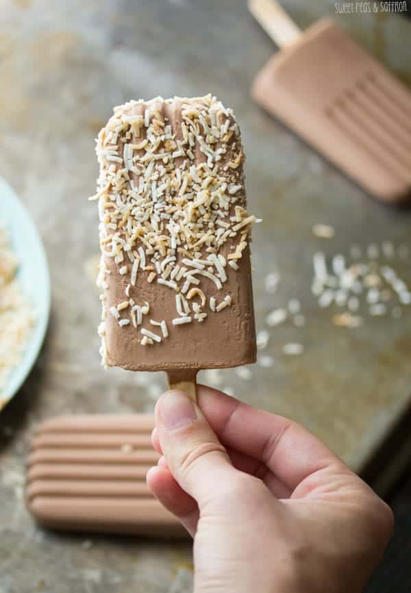Close up shot of Nutella Popsicle dipped in toasted coconut