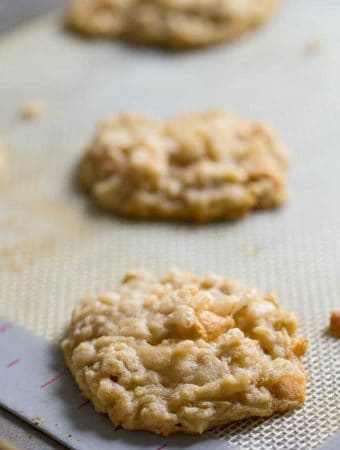 two butterscotch oatmeal rice krispie cookies on silicone parchment