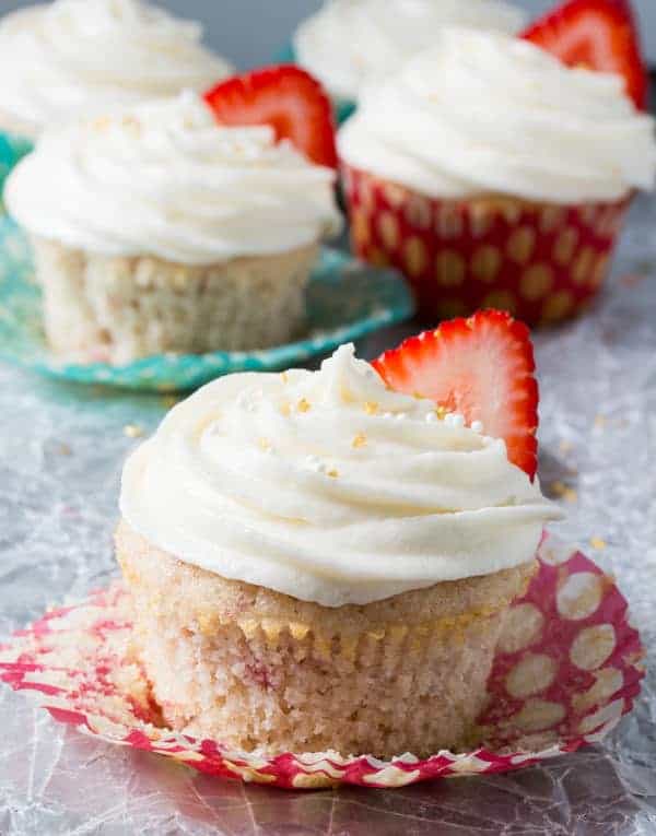 Close up view of Strawberry Cupcakes with Champagne Frosting on a cupcake wrapper