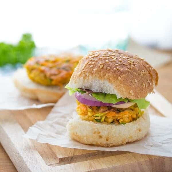 mini moroccan chickpea burgers with spicy harissa mayo on parchment