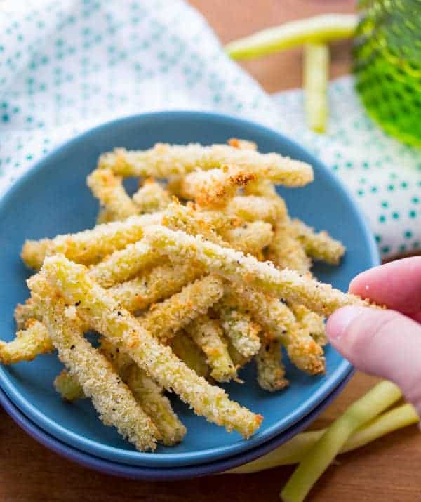 Close up view of Crispy Parmesan Baked Green Bean Fries in blue bowl and napkin
