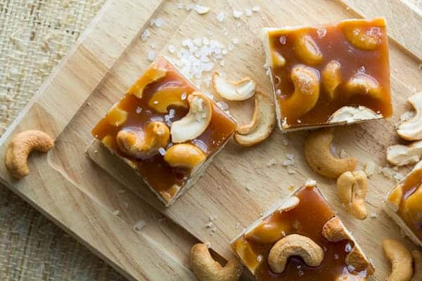 Overhead view of three Cashew Salted Caramel Bars on cutting board