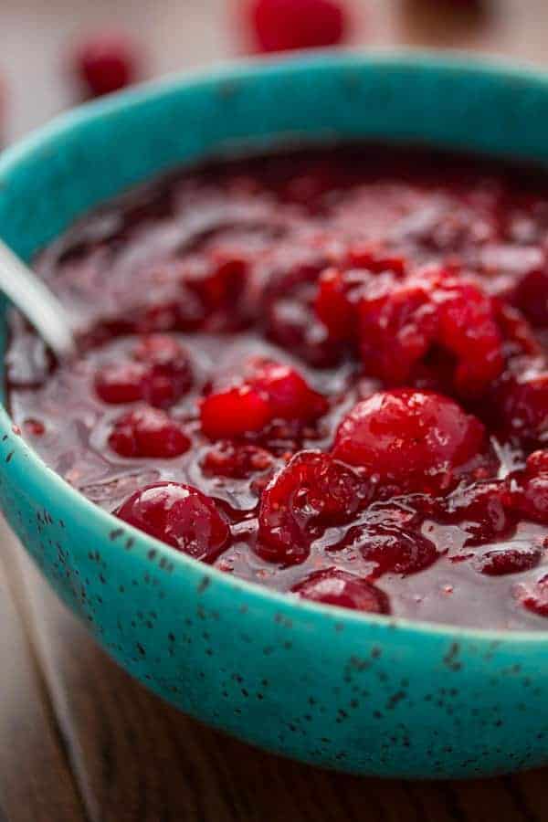 Close up shot of Raspberry Balsamic Cranberry Sauce in blue bowl