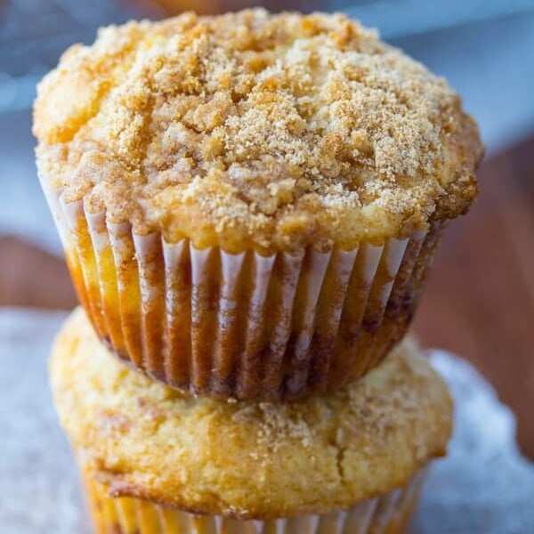 stack of two apple coffee cake muffins on parchment
