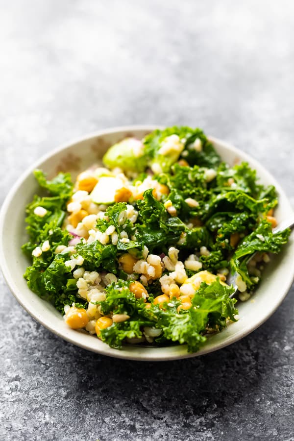 kale barley salad in bowl after tossing