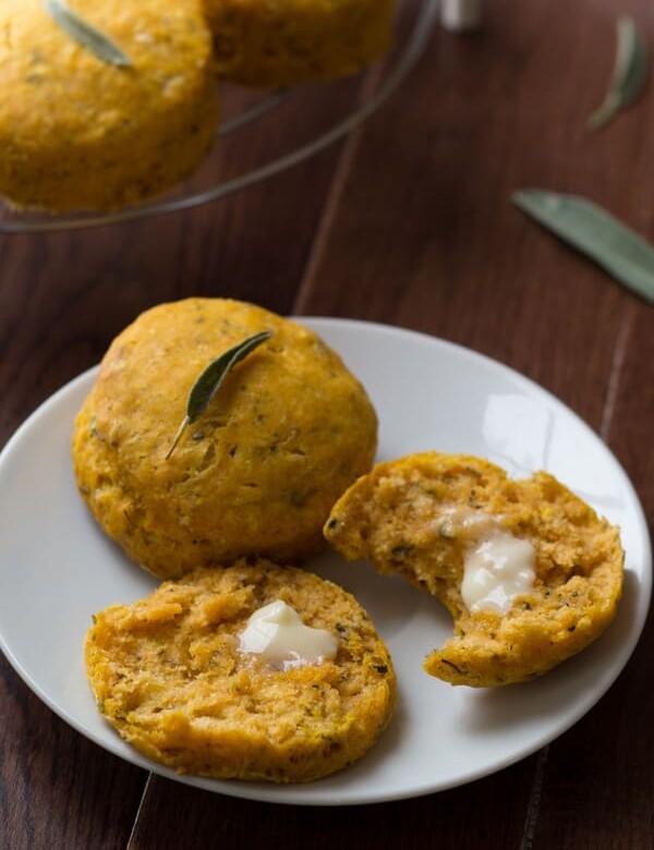 pumpkin biscuits with sage on white plate with butter