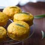 five pumpkin biscuits with sage on wire rack