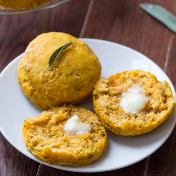 Pumpkin Biscuits with Sage arranged on a plate cut open with melting butter