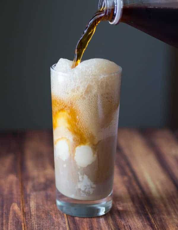 Spiced Baileys Root Beer Float with bottle of root beer being poured into glass