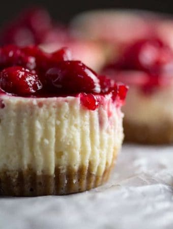 side view of leftover cranberry sauce mini cheesecake on parchment