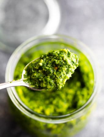 Close up shot of spoonful of healthy kale pesto