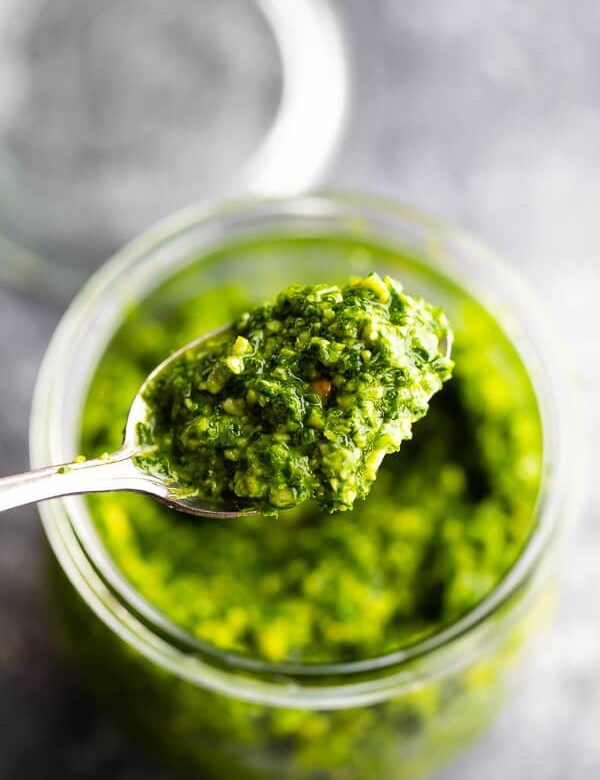 Close up shot of spoonful of healthy kale pesto