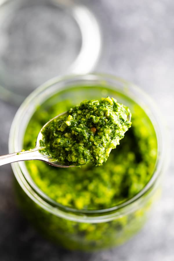 close up shot of spoon with kale pesto on it