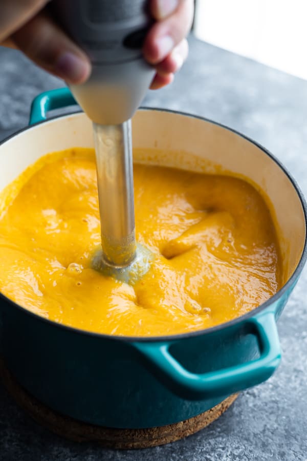 immersion blender blending orange soup