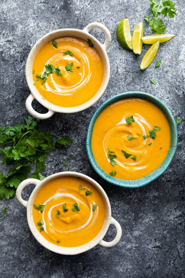 overhead view of three bowls of thai curry sweet potato soup