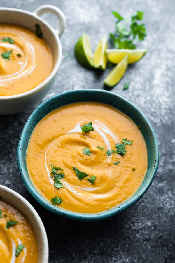 close up shot of the red lentil soup in blue bowl