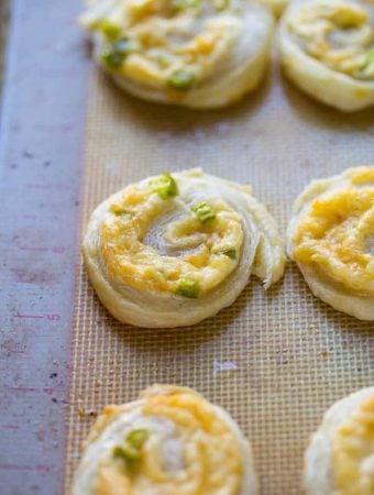 jalapeno and smoked gouda puff pastry pinwheels on silicone tray