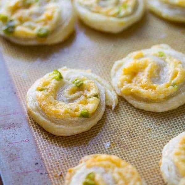 jalapeno and smoked gouda puff pastry pinwheels on silicone tray