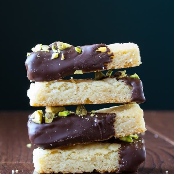 stack of four cardamom and chocolate shortbread cookies with salted pistachios