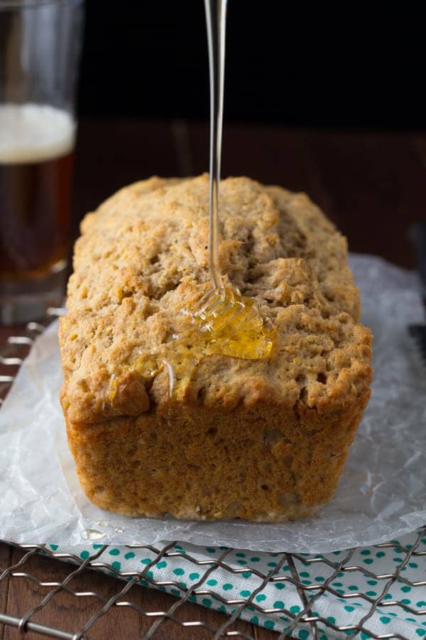 side on shot of honey rye beer bread with honey being drizzled on it