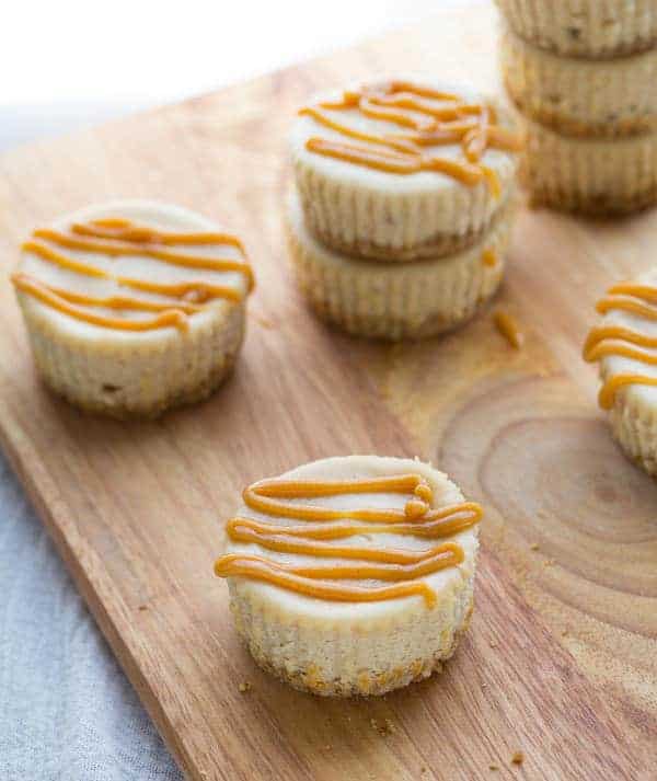 mini peanut butter cup cheesecakes drizzled with melted peanut butter chips