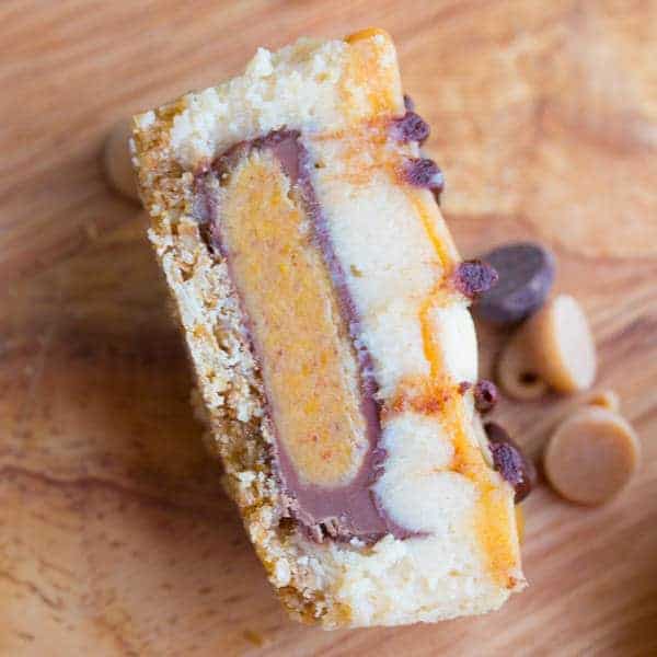 overhead close up of mini cheesecake cut in half revealing a peanut butter cup inside